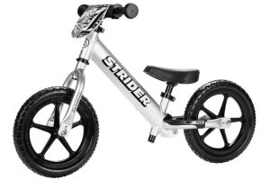 Angled view of a silver Strider 12 Pro balance bike